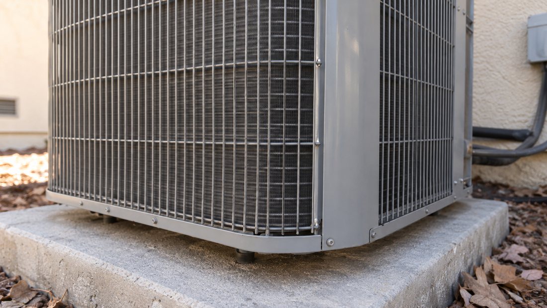 Close view of a residential outdoor condenser cabinet and coil fins